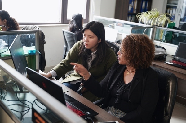 梅德哈妮（右）與中國同事討論設(shè)計方案。受訪對象供圖