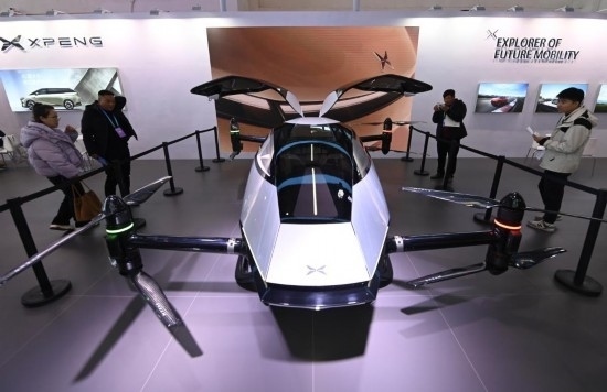 2023年12月1日，在鏈博會智能汽車鏈展區(qū)小鵬汽車展臺，參觀者觀看一臺智能飛行器。新華社記者蔡湘鑫攝