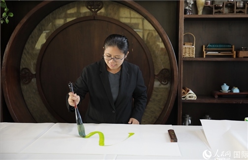 緬甸駐華大使館副館長、公使銜參贊杜欣瑪泰參加《五百筆·瀾湄合作》集體藝術(shù)創(chuàng)作。人民網(wǎng)王婧攝