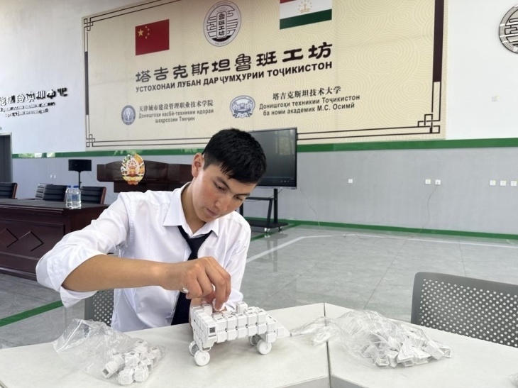 在塔吉克斯坦魯班工坊內(nèi)，學(xué)員正在操作能力源創(chuàng)新套件。本報(bào)記者 屈佩 攝