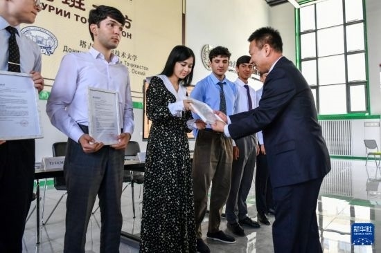 7月3日，在塔吉克斯坦首都杜尚別，天津城市建設(shè)管理職業(yè)技術(shù)學(xué)院的負責(zé)人為魯班工坊赴華留學(xué)生頒發(fā)錄取通知書。新華社記者 曹陽 攝