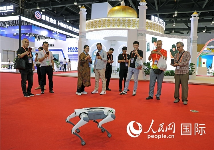 東博會上，觀眾正在參觀一只機(jī)器狗。綠色能源、新能源汽車、綠色農(nóng)產(chǎn)品等成為本屆東博會觀眾關(guān)注的焦點(diǎn)。人民網(wǎng)記者 趙益普攝