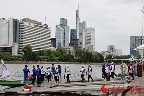 來自美國的快樂龍舟隊(duì)選手們正在登船準(zhǔn)備參賽。人民網(wǎng)記者 劉仲華攝