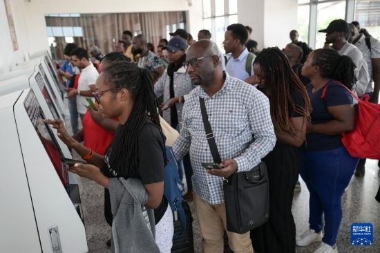 5月31日，在蒙內(nèi)鐵路內(nèi)羅畢站，乘客在自助取票機前排隊取票。新華社記者 楊光 攝